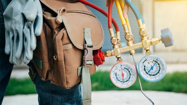 air conditioner installer with his gauges